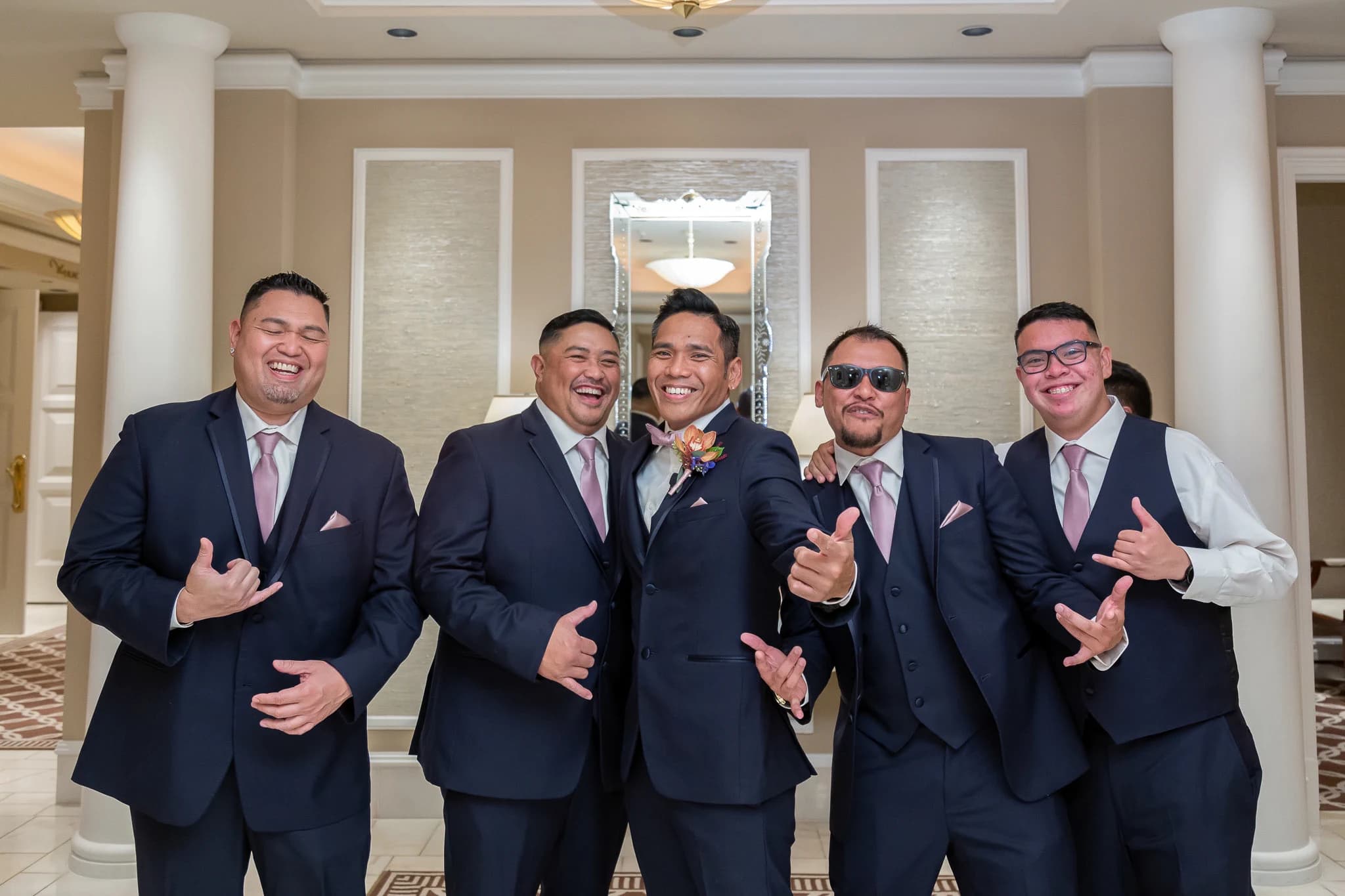 Groom and groomsmen laugh together before the wedding